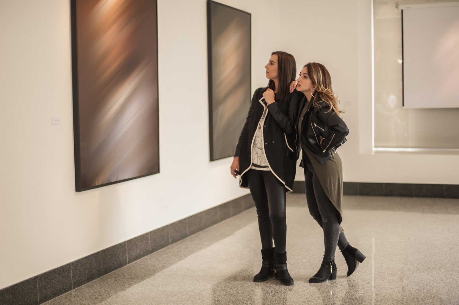 Visitors looking at a modern painting, one of the free things to do in Northwest Arkansas